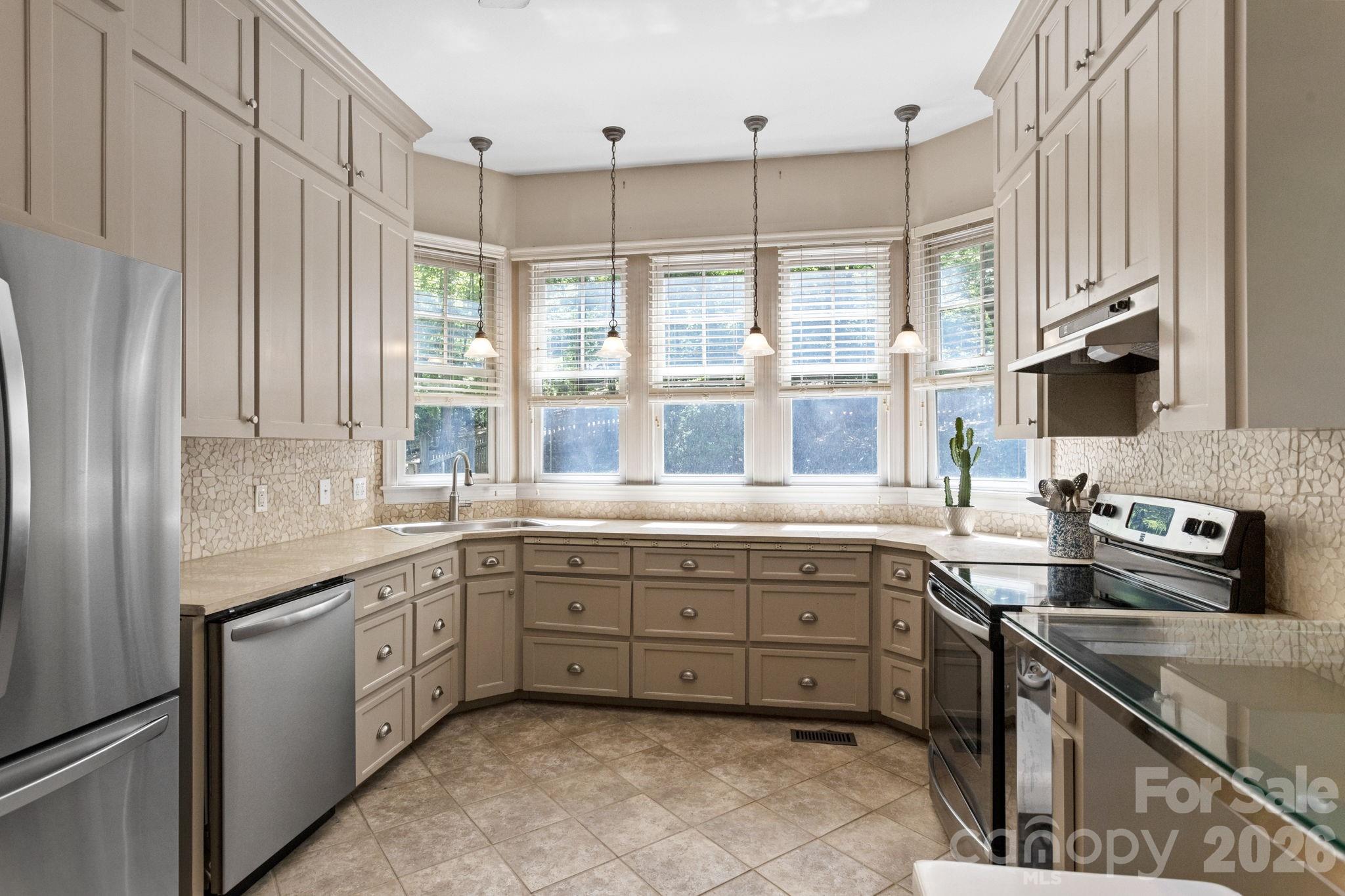2825 Hunting Country Road Tryon, NC 28782 - Photo 13 of 41 a kitchen with a sink stove and cabinets