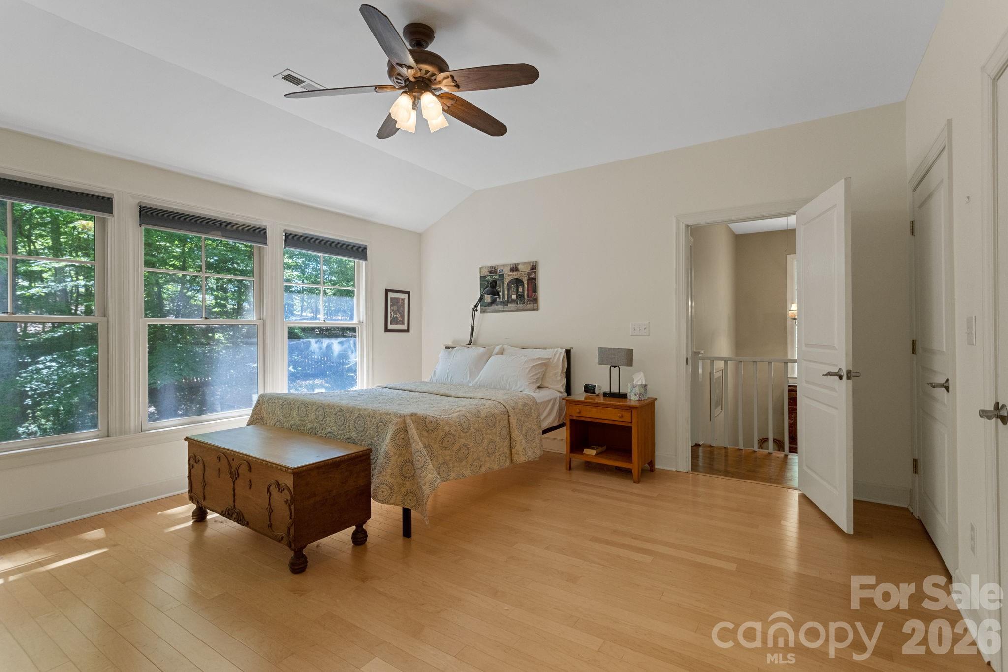 2825 Hunting Country Road Tryon, NC 28782 - Photo 26 of 41 a spacious bedroom with a bed a couch and a table