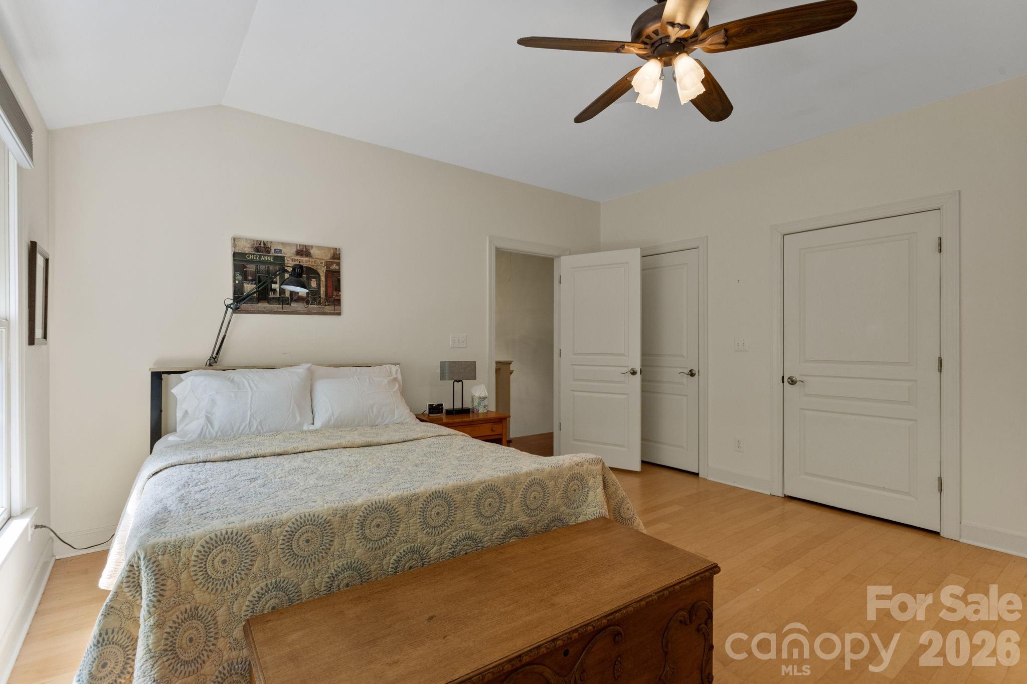 2825 Hunting Country Road Tryon, NC 28782 - Photo 27 of 41 a bedroom with a bed and a chandelier
