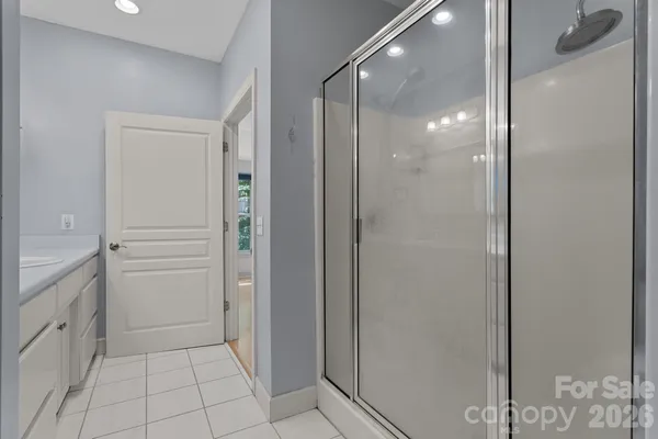 a bathroom with a shower and a sink