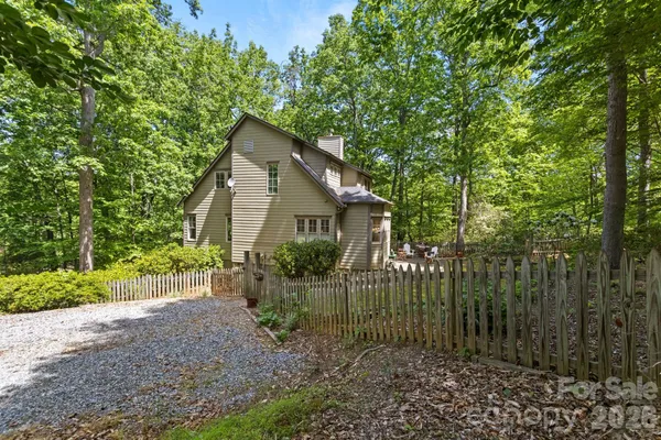 a view of a house with a small yard and plants