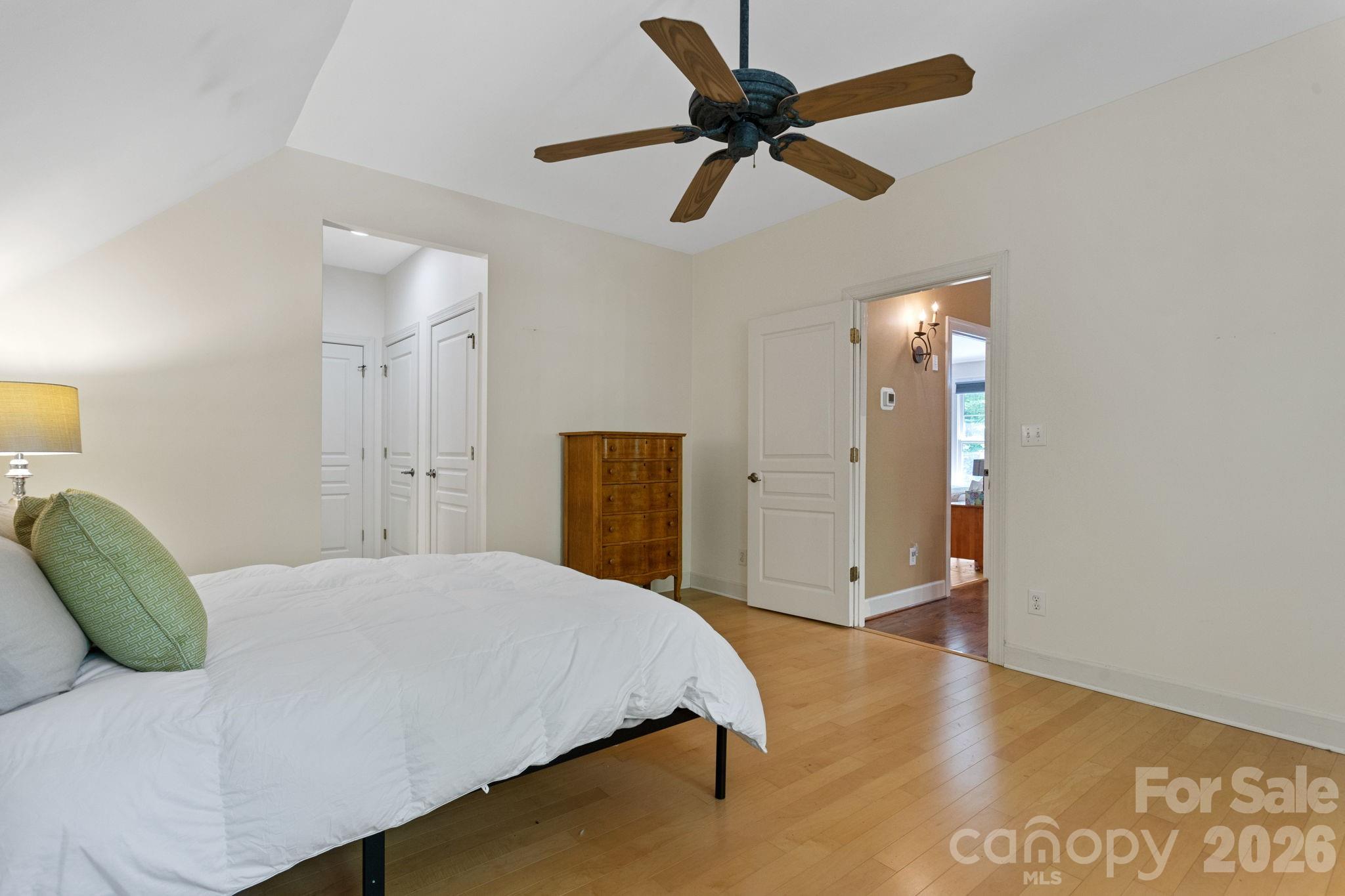 2825 Hunting Country Road Tryon, NC 28782 - Photo 32 of 41 a spacious bedroom with a bed and a ceiling fan