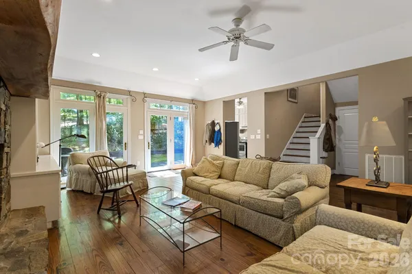 a living room with furniture and wooden floor