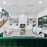 a living room with fireplace furniture and a chandelier
