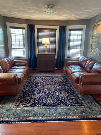 a living room with furniture and a rug