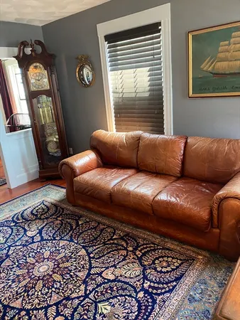 a living room with a couch and a window