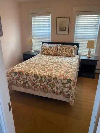 a bedroom with a bed and window