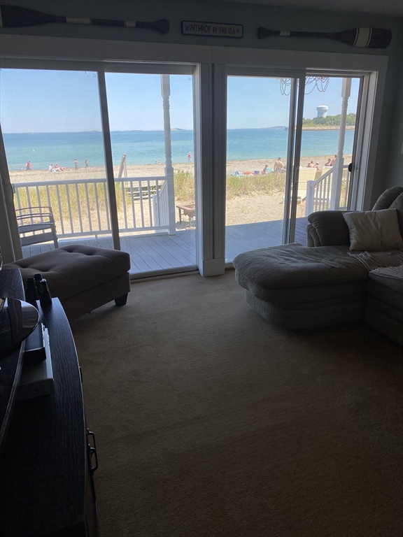 876 Shirley Street, Unit 1 Winthrop, MA 02152 - Photo 10 of 14 a living room with furniture and a floor to ceiling window