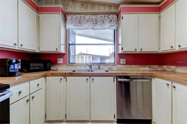 a kitchen with stainless steel appliances granite countertop a sink and cabinets