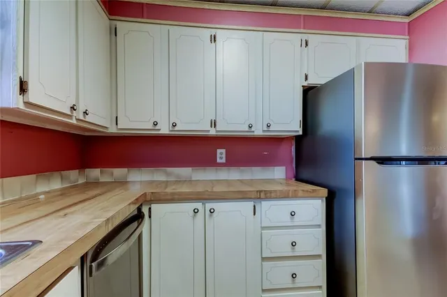 a kitchen with stainless steel appliances granite countertop a refrigerator and a stove