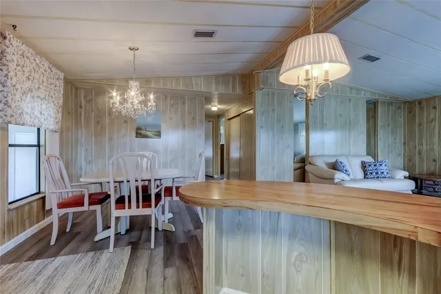 a large kitchen with a table and chairs