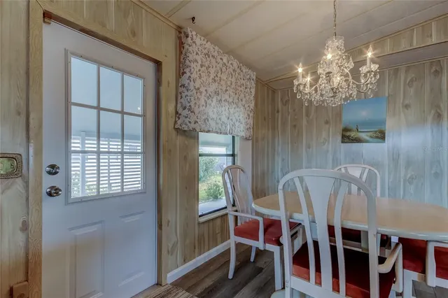 a view of a dining room with furniture and chandelier