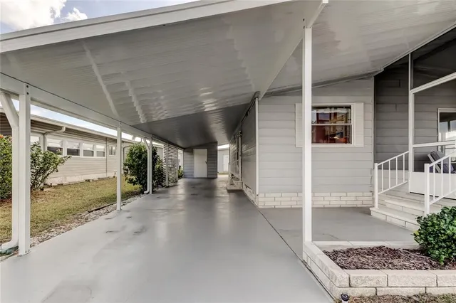 a view of a street with a building and palm tree