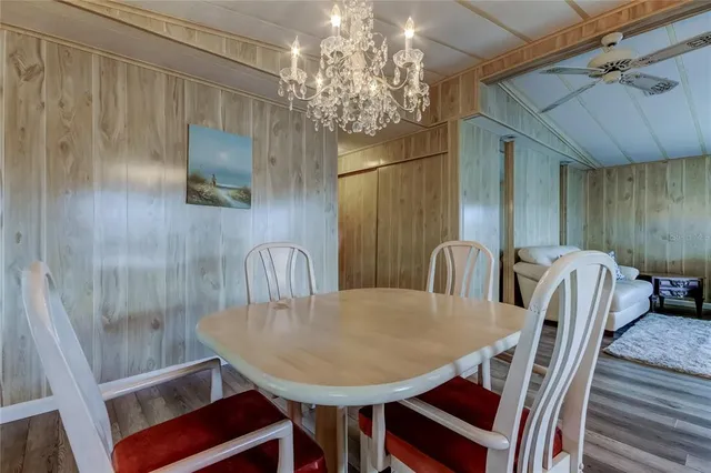 a view of a dining room with furniture and chandelier