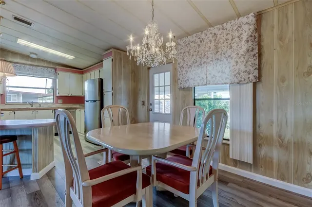 a view of a dining room with furniture and chandelier