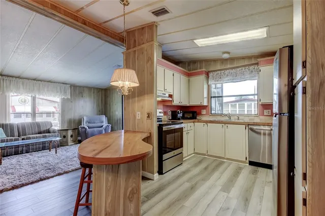 a kitchen with sink cabinets and window