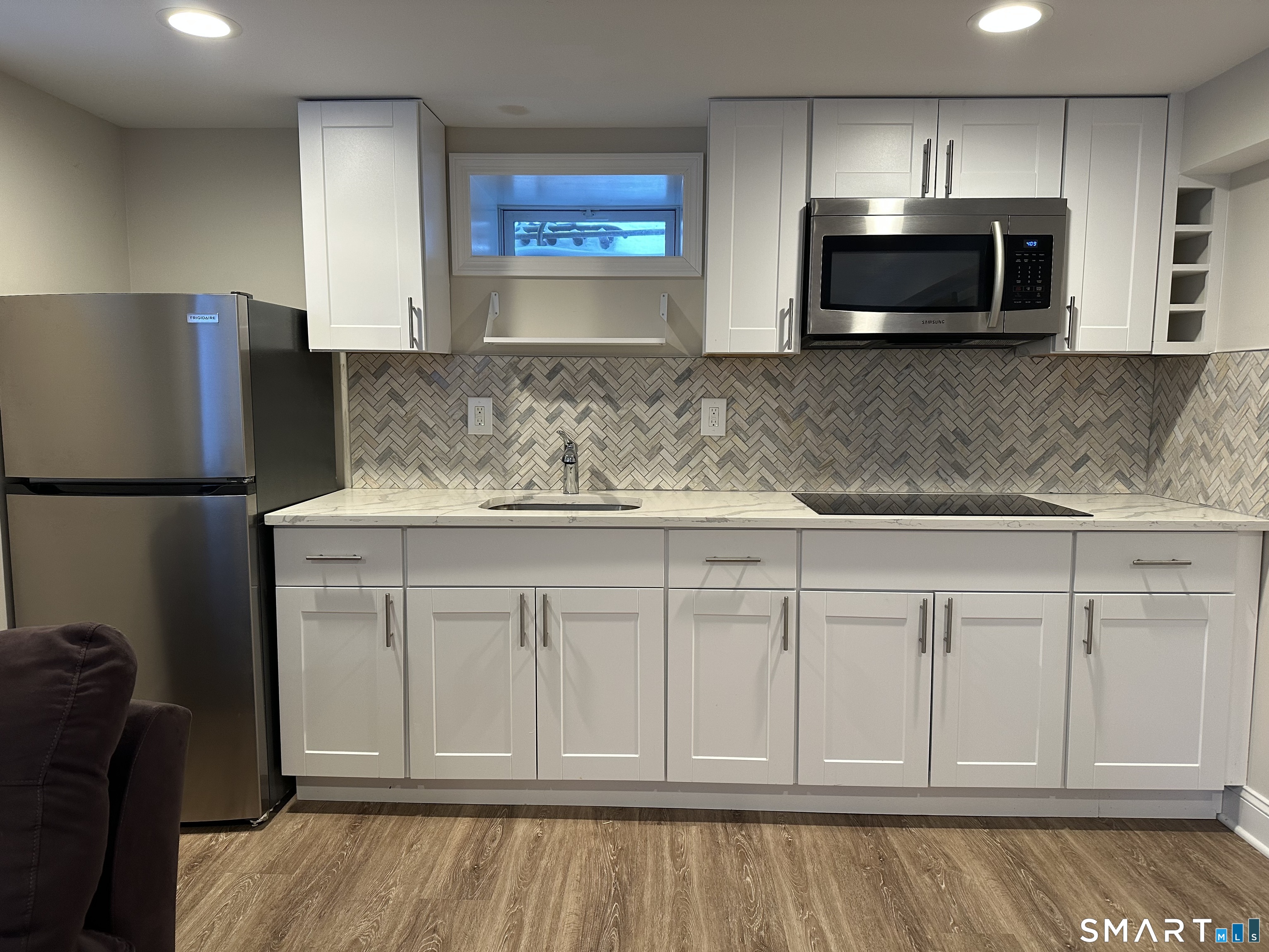2 Hurd Street Shelton, CT 06484 - Photo 5 of 19 Remodeled kitchen, white shaker cabinets, quartz countertop, built in microwave and cooktop.