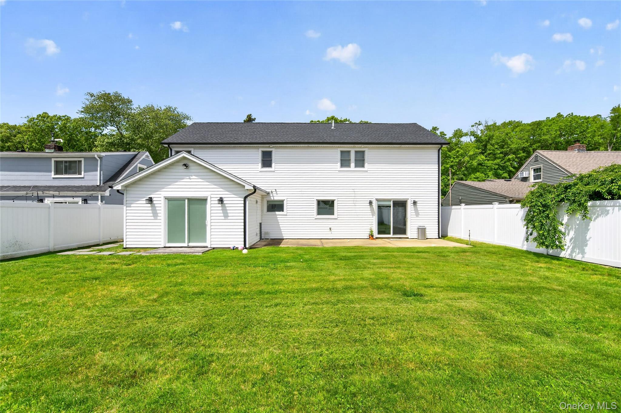 534 Riverside Avenue Massapequa, NY 11758 - Photo 26 of 28 a view of a yard in front of a house with plants and trees