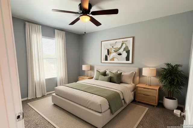 a bedroom with a large bed and a chandelier