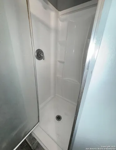 a bathroom with a glass shower door