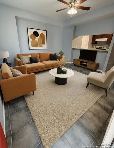 a living room with furniture and a ceiling fan