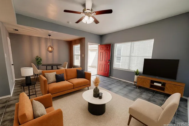 a living room with furniture and a flat screen tv