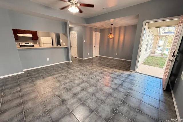 a view of a big room with windows and cabinet