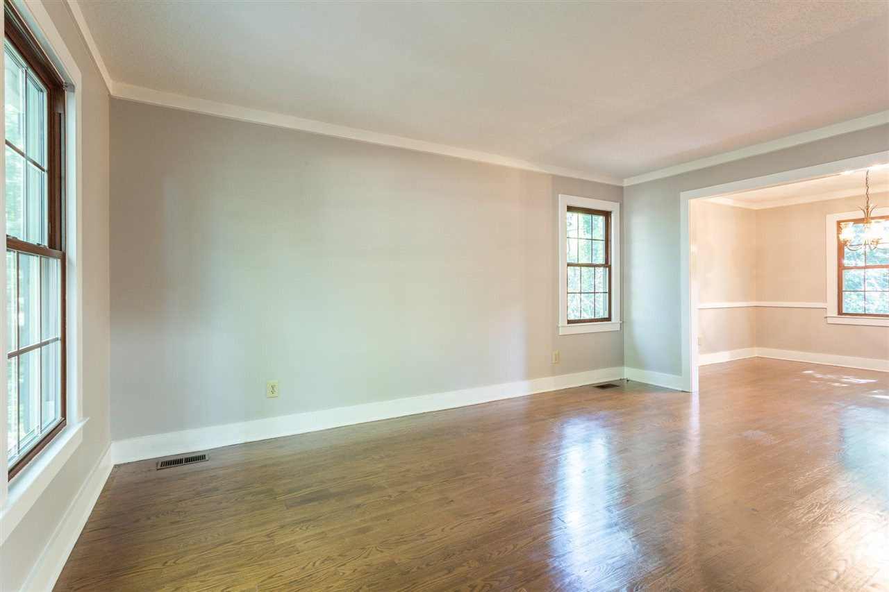 8816 Woodstone Drive Raleigh, NC 27615 - Photo 5 of 30 Large Formal Living Room with hardwood flooring, lots of natural light, and wide molding accents. Move in Condition with fresh paint and new appliances. Living Room