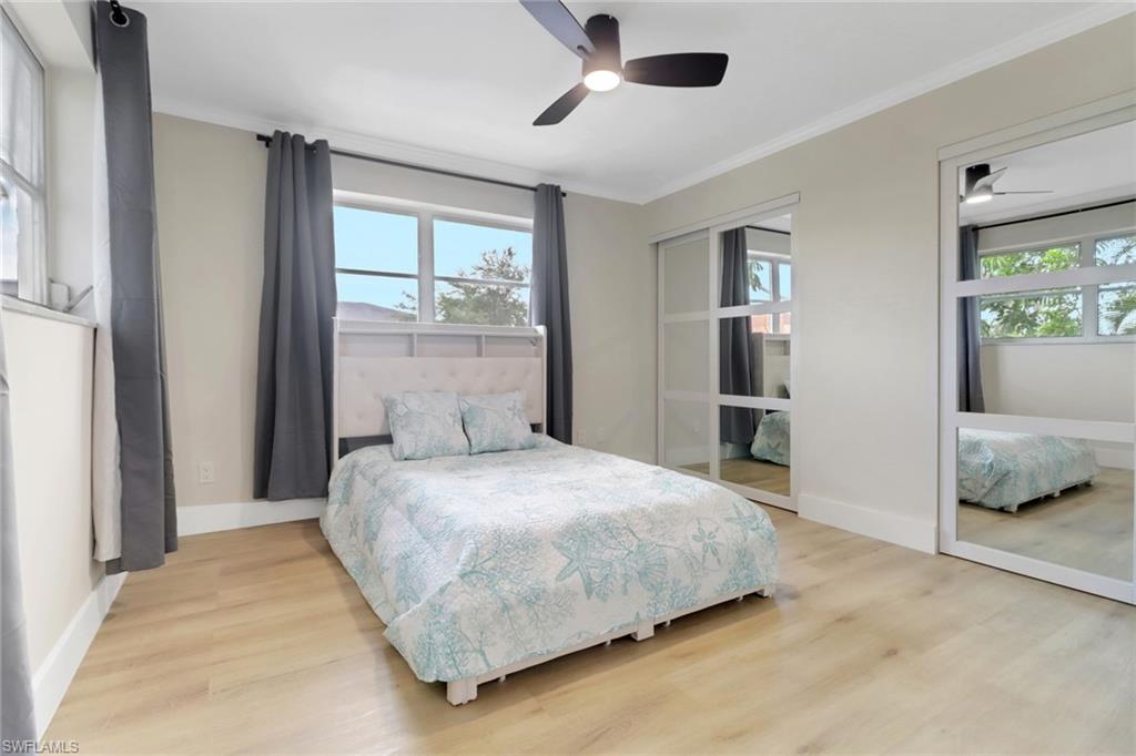 1195 Clam Court, Unit 202 Naples, FL 34102 - Photo 12 of 18 a bedroom with a bed and large window