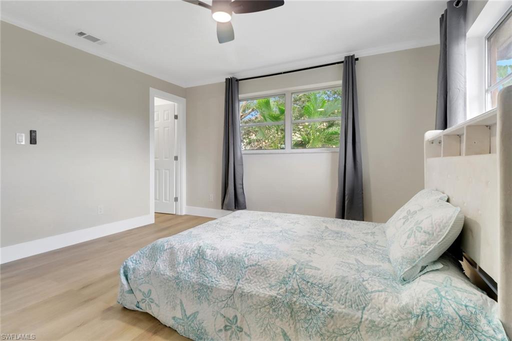 1195 Clam Court, Unit 202 Naples, FL 34102 - Photo 13 of 18 a bedroom with a bed and a window