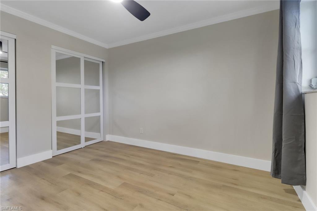 1195 Clam Court, Unit 202 Naples, FL 34102 - Photo 17 of 18 an empty room with a empty space and a window