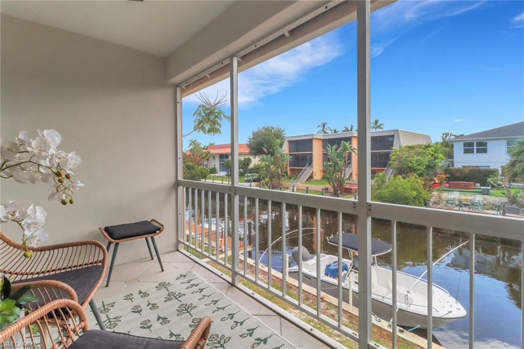 1195 Clam Court, Unit 202 Naples, FL 34102 - Photo 5 of 18 a view of a balcony with chairs