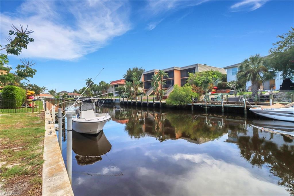 1195 Clam Court, Unit 202 Naples, FL 34102 - Photo 6 of 18 a view of a lake with a house in the background