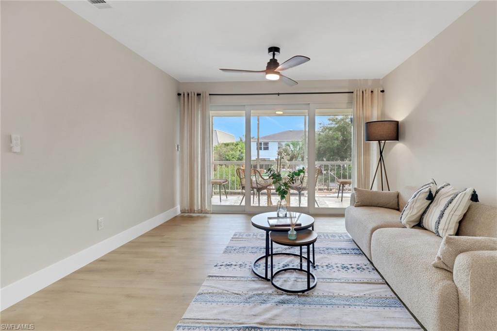 1195 Clam Court, Unit 202 Naples, FL 34102 - Photo 10 of 18 a living room with furniture and a large window