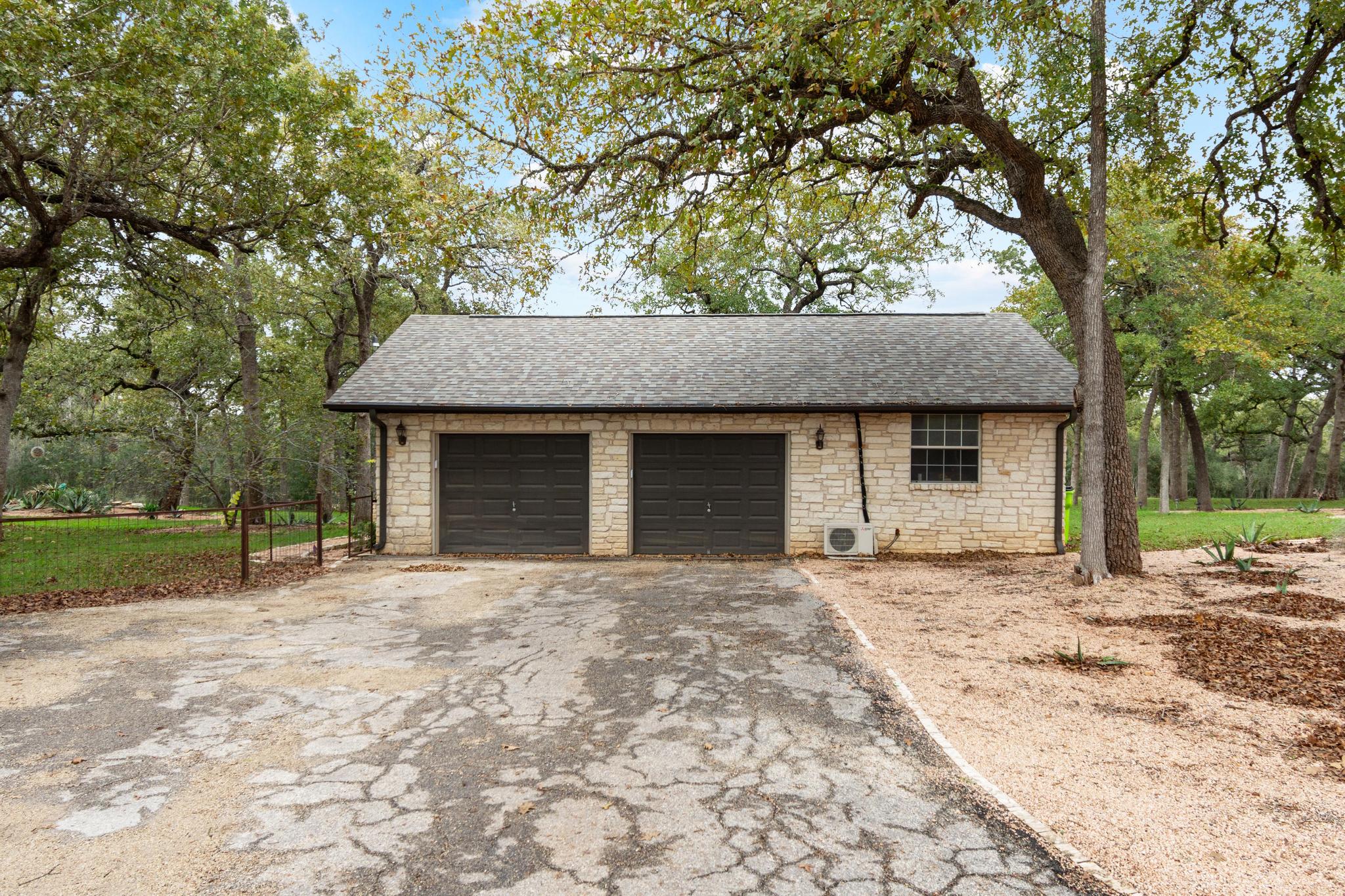 346 The Oaks Boulevard Elgin, TX 78621 - Photo 33 of 39 a front view of a house with a garden and trees