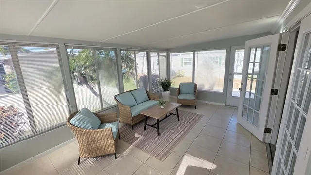 a living room with furniture and a floor to ceiling window