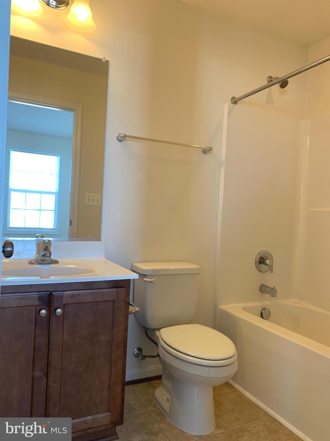 17269 Library Boulevard Ruther Glen, VA 22546 - Photo 12 of 14 a bathroom with a sink a toilet and shower