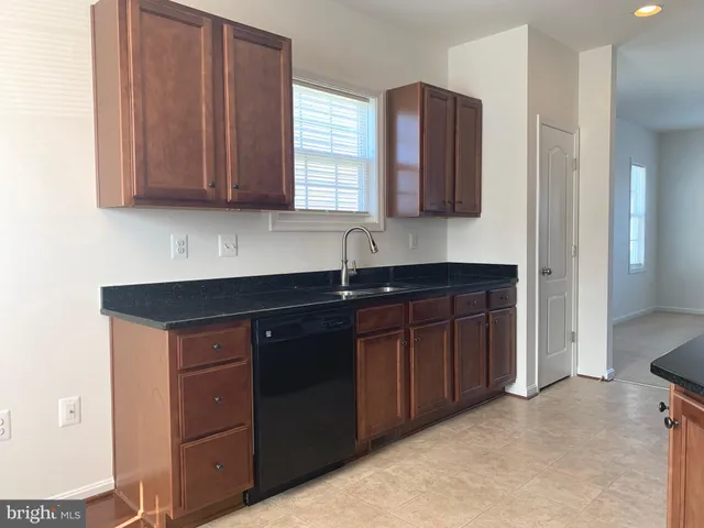 a kitchen with stainless steel appliances granite countertop a sink and cabinets