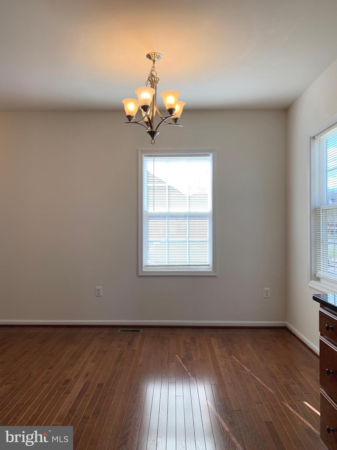 17269 Library Boulevard Ruther Glen, VA 22546 - Photo 6 of 14 an empty room with wooden floor and windows