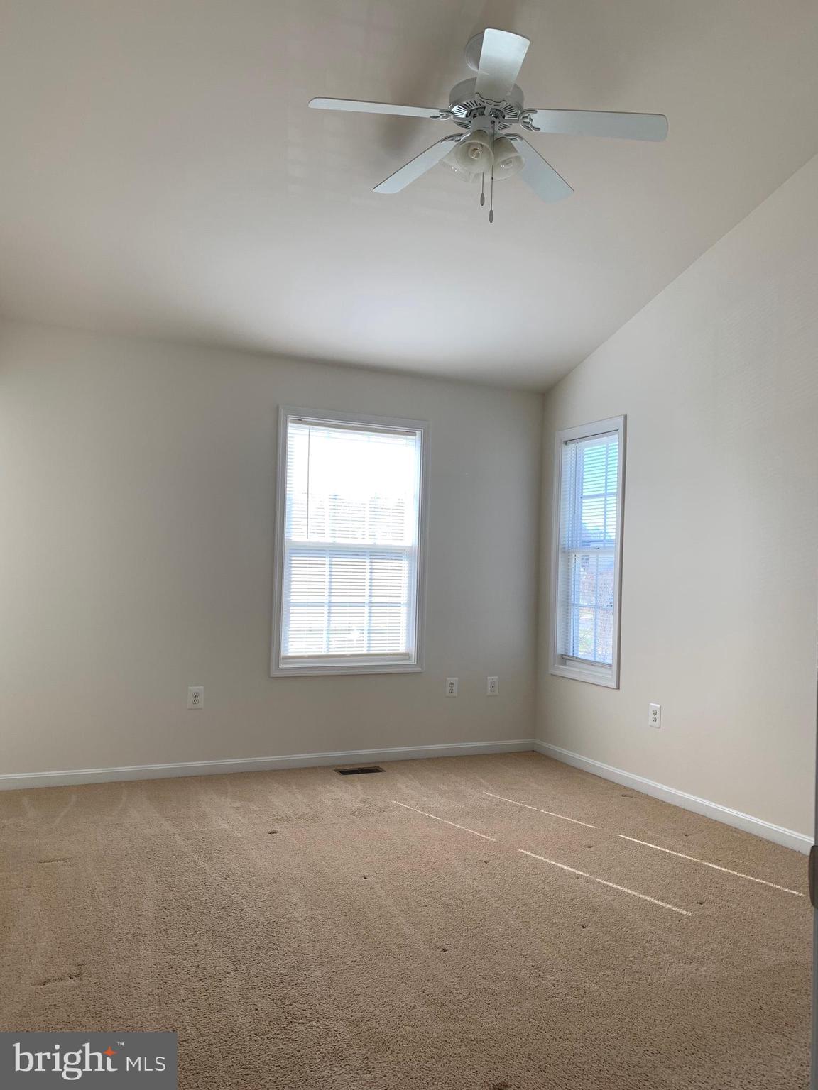 17269 Library Boulevard Ruther Glen, VA 22546 - Photo 8 of 14 an empty room with a window and a ceiling fan