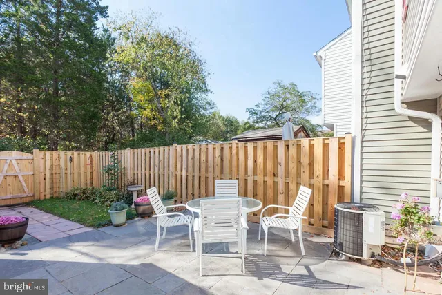 a view of a chairs and table in backyard