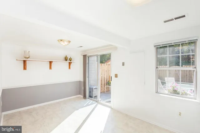 a view of hallway with bathroom and windows