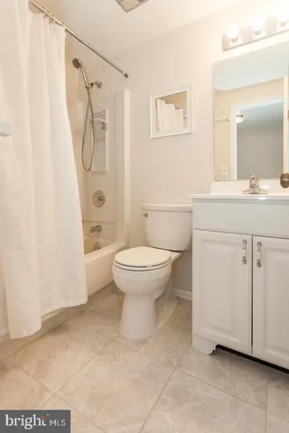 a bathroom with a granite countertop sink a toilet and a mirror