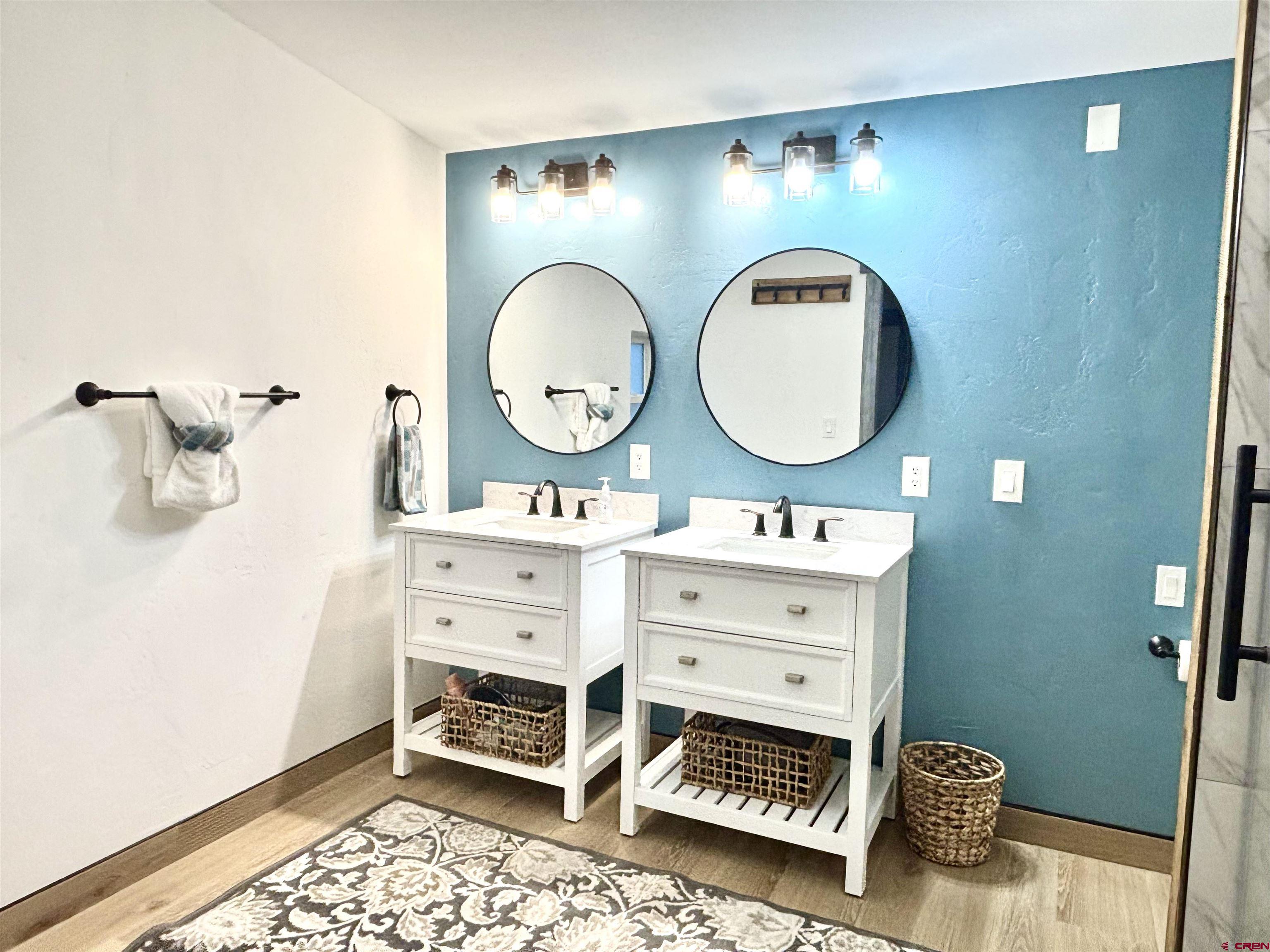 28 Raspberry Circle Durango, CO 81301 - Photo 16 of 26 a bathroom with a sink a mirror and a shower