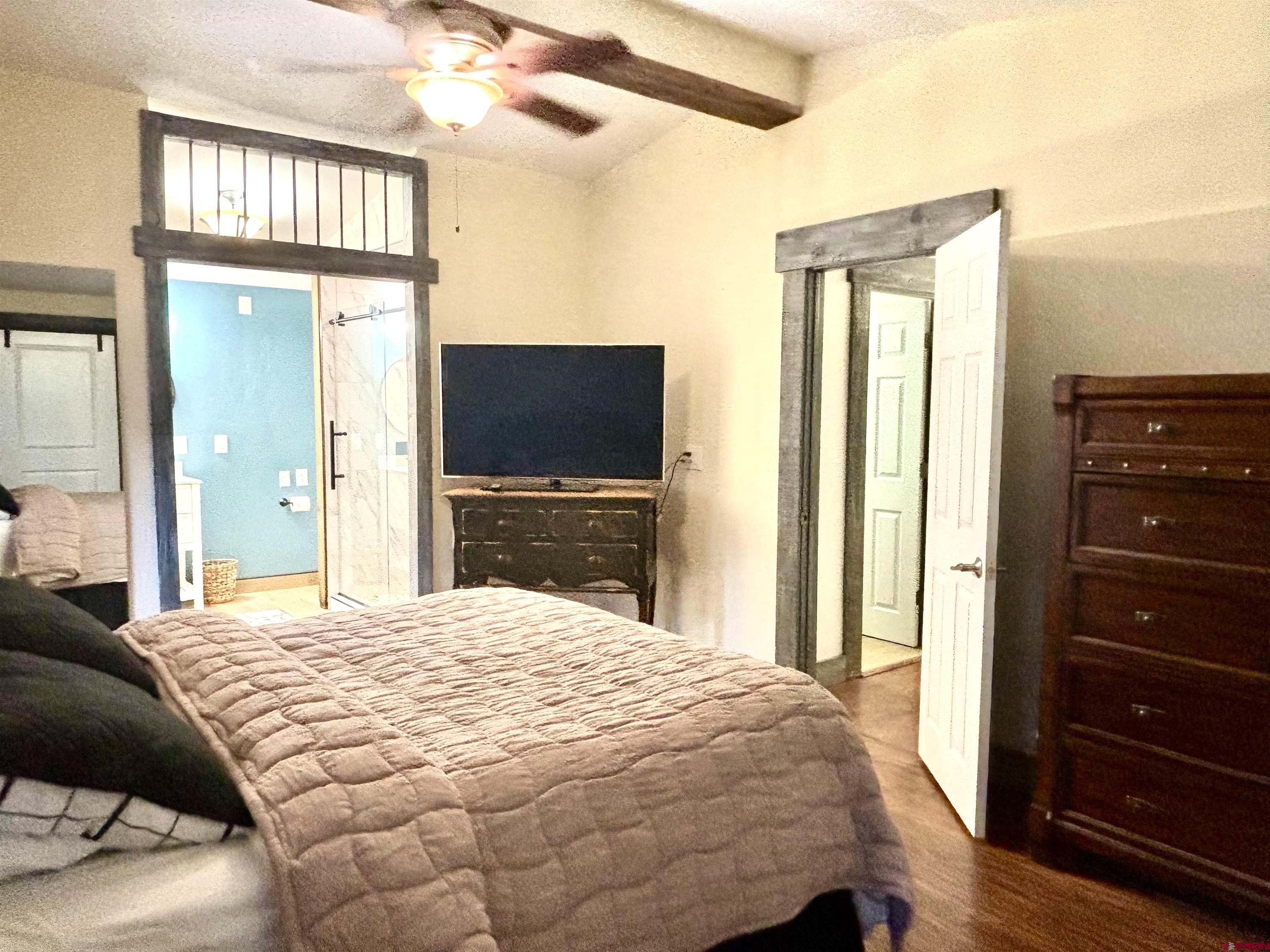 28 Raspberry Circle Durango, CO 81301 - Photo 18 of 26 a bedroom with a bed and a flat tv screen on dresser