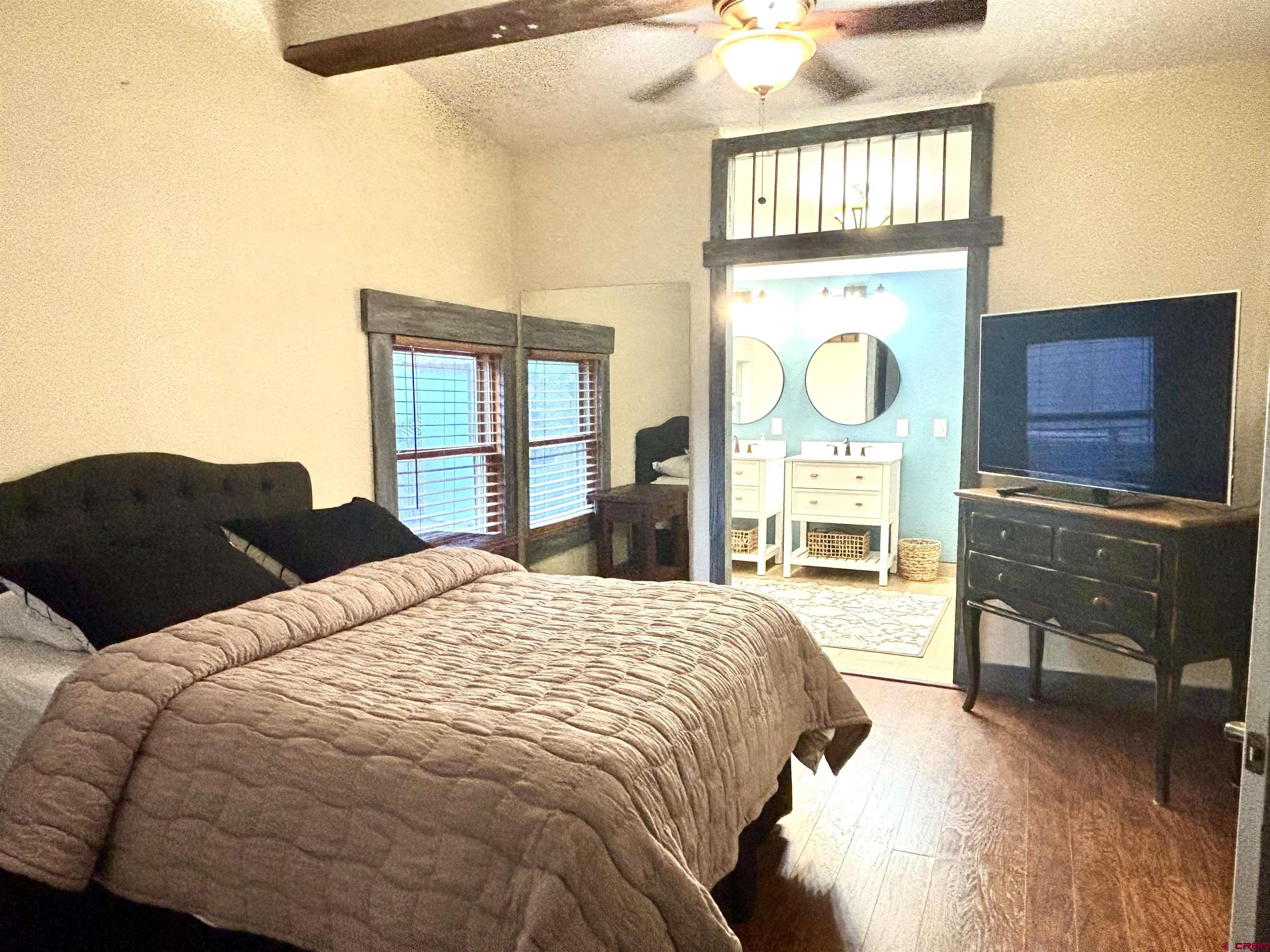 28 Raspberry Circle Durango, CO 81301 - Photo 19 of 26 a bedroom with a bed and a dresser with mirror