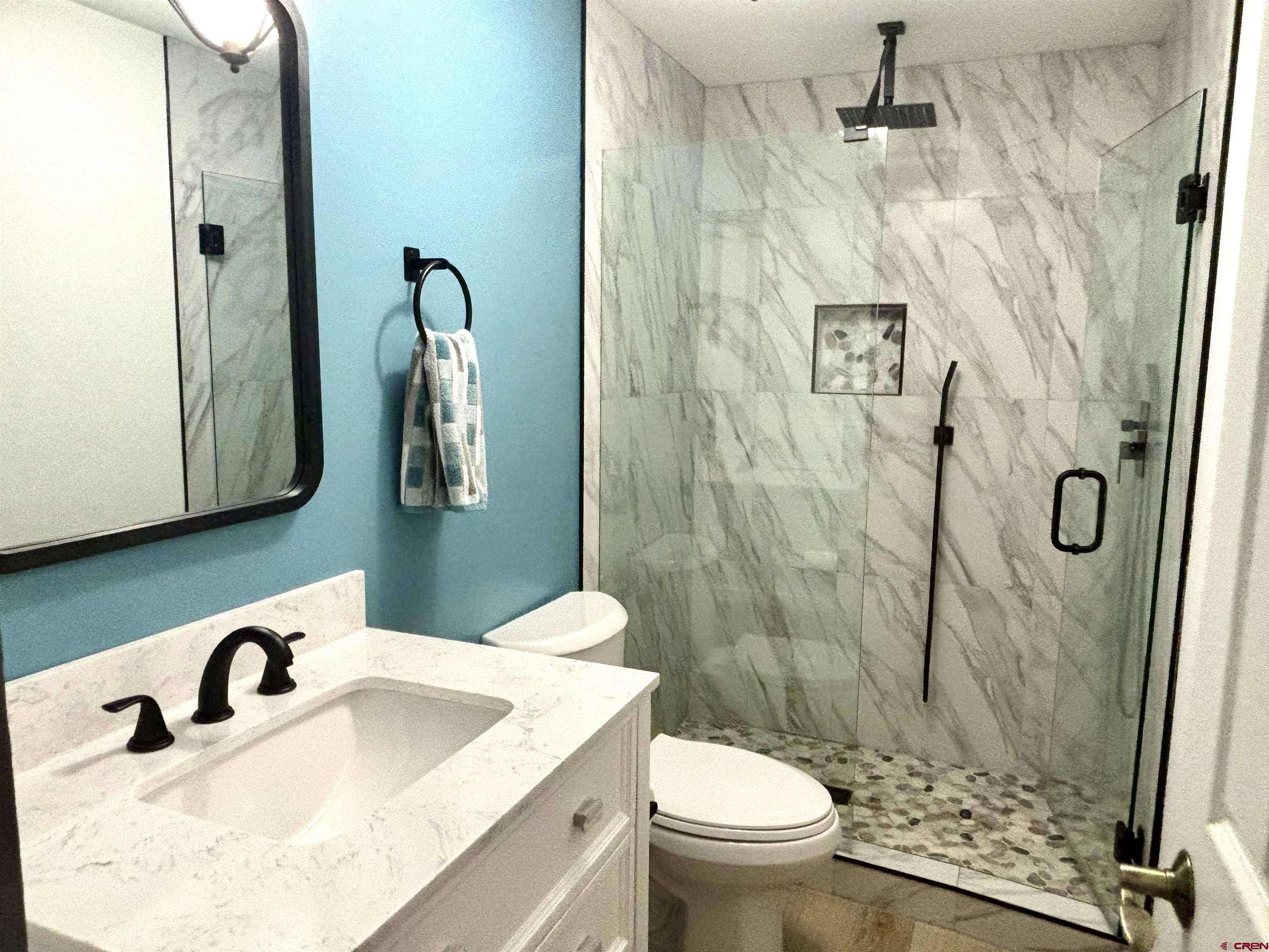 28 Raspberry Circle Durango, CO 81301 - Photo 21 of 26 a bathroom with a sink toilet and shower