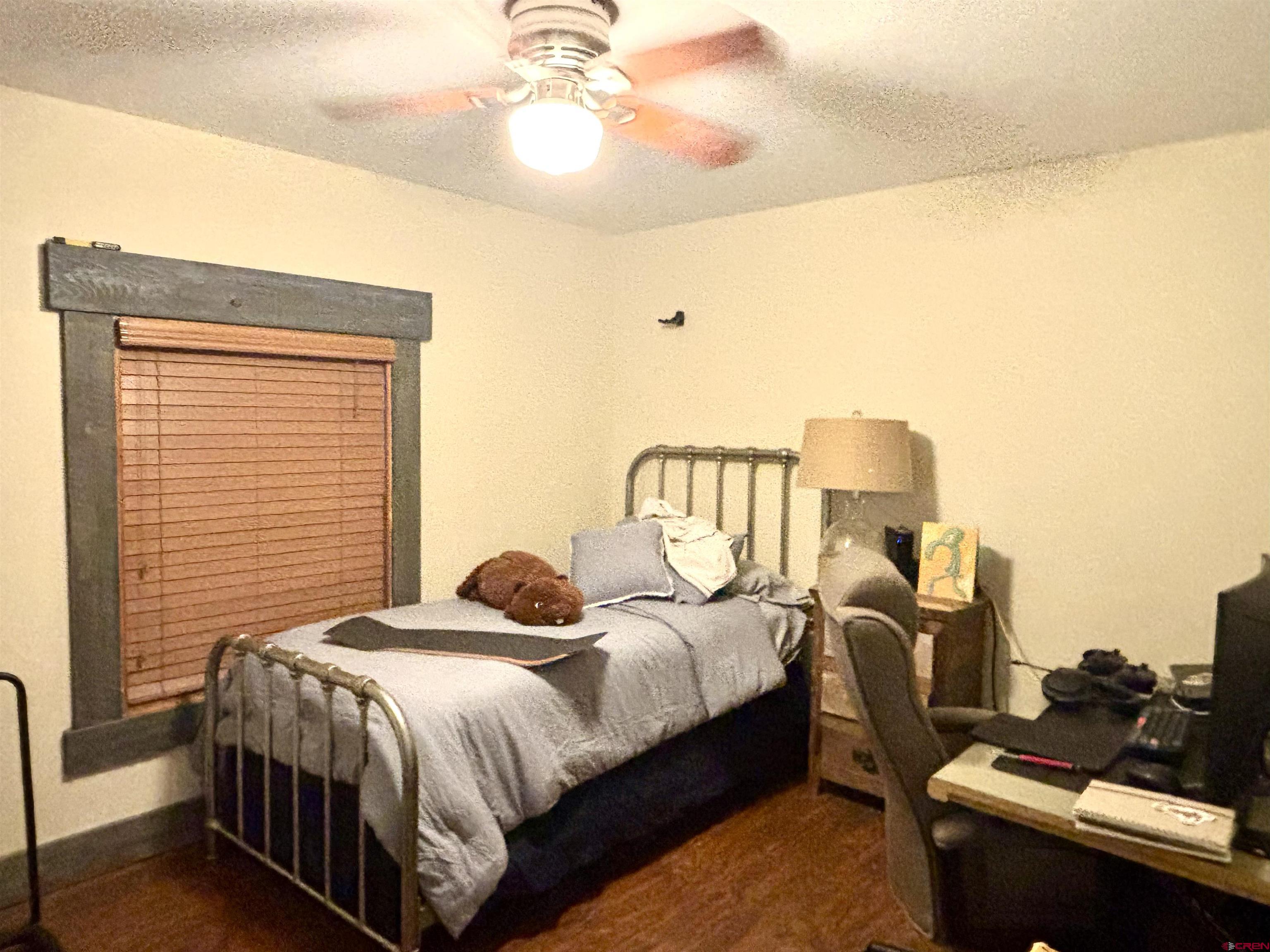 28 Raspberry Circle Durango, CO 81301 - Photo 22 of 26 a bedroom with a bed and wooden floor