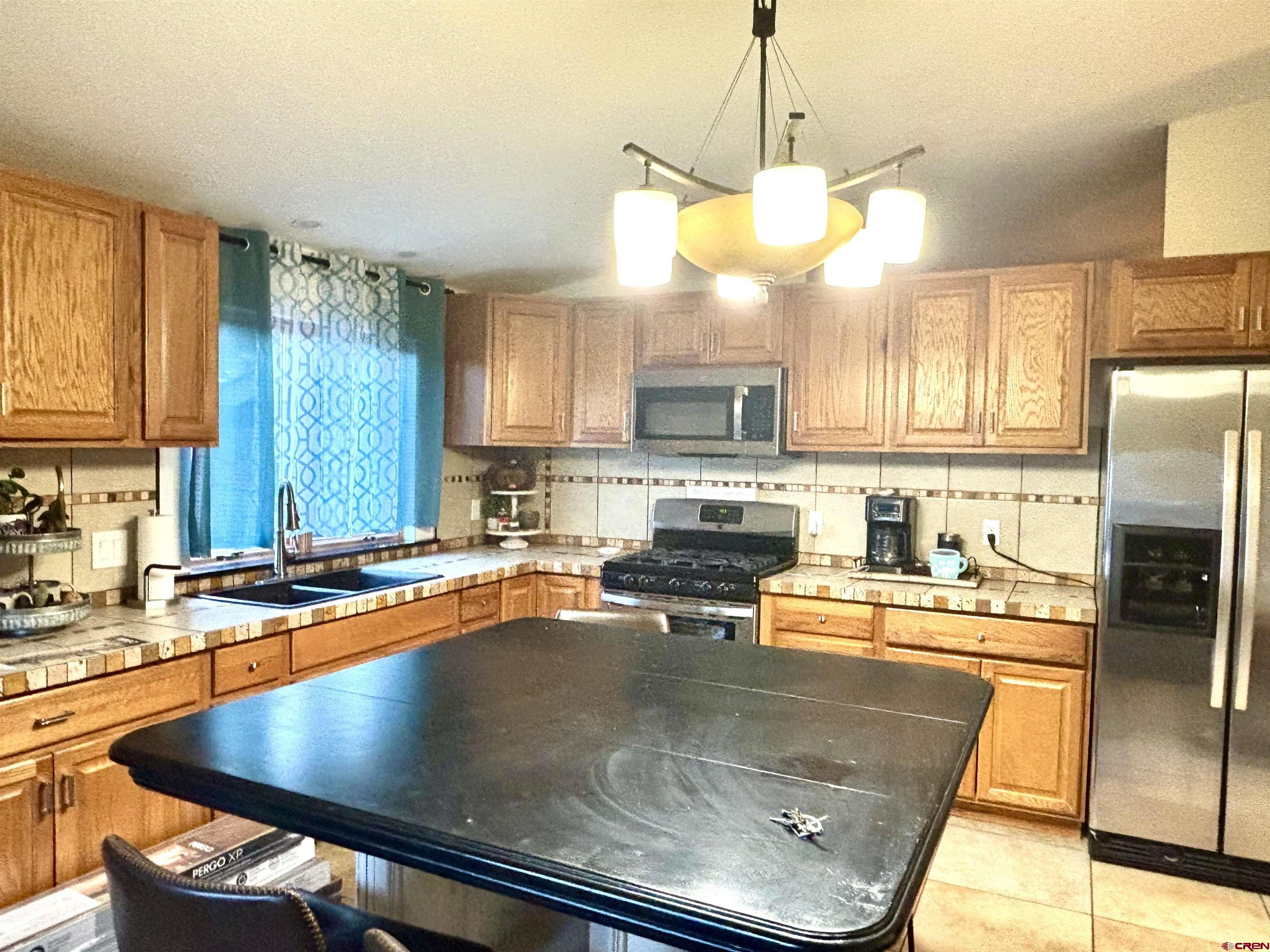 28 Raspberry Circle Durango, CO 81301 - Photo 7 of 26 a kitchen with stainless steel appliances granite countertop a sink a stove and refrigerator