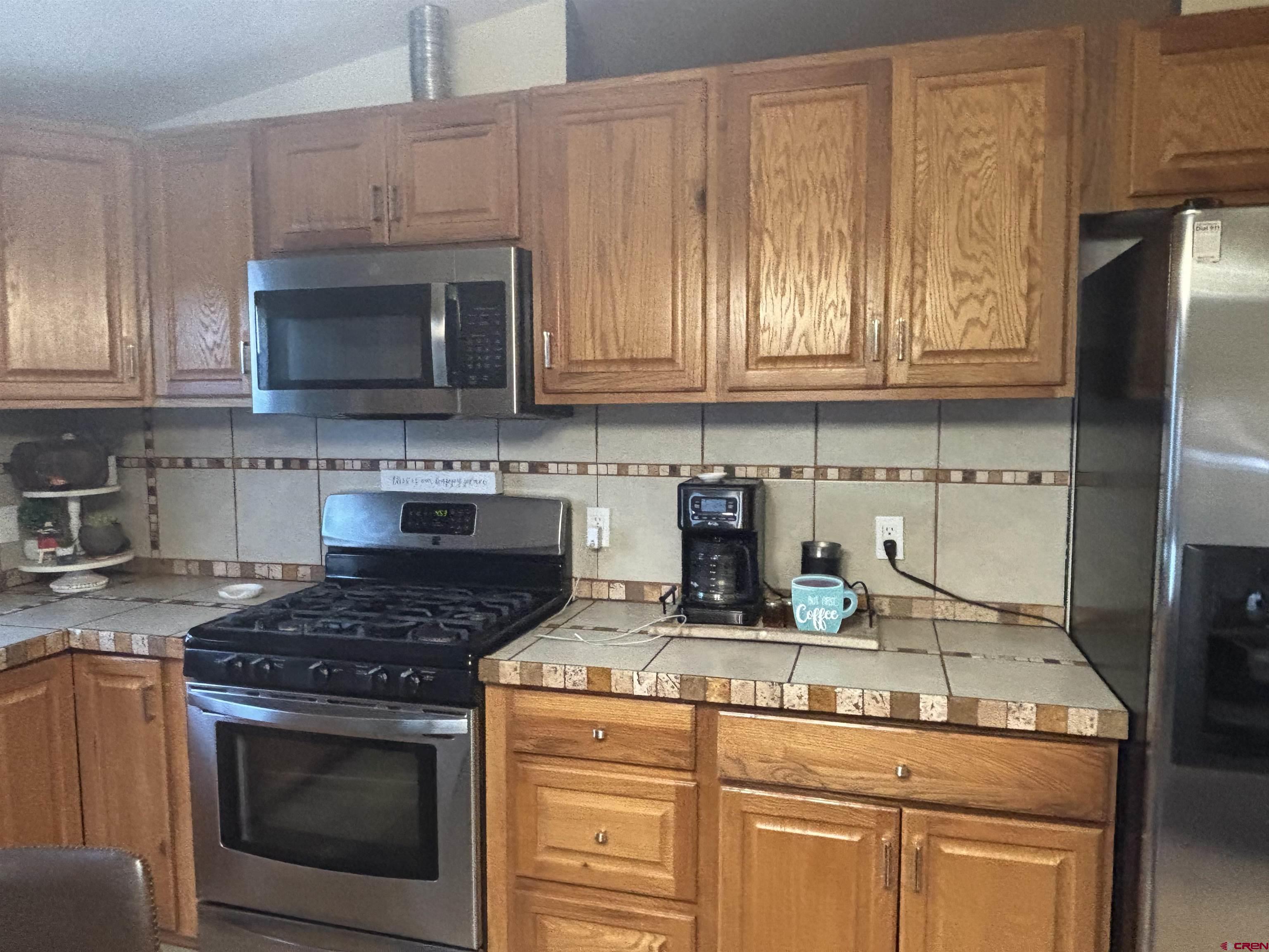 28 Raspberry Circle Durango, CO 81301 - Photo 8 of 26 a kitchen with granite countertop a stove sink and cabinets